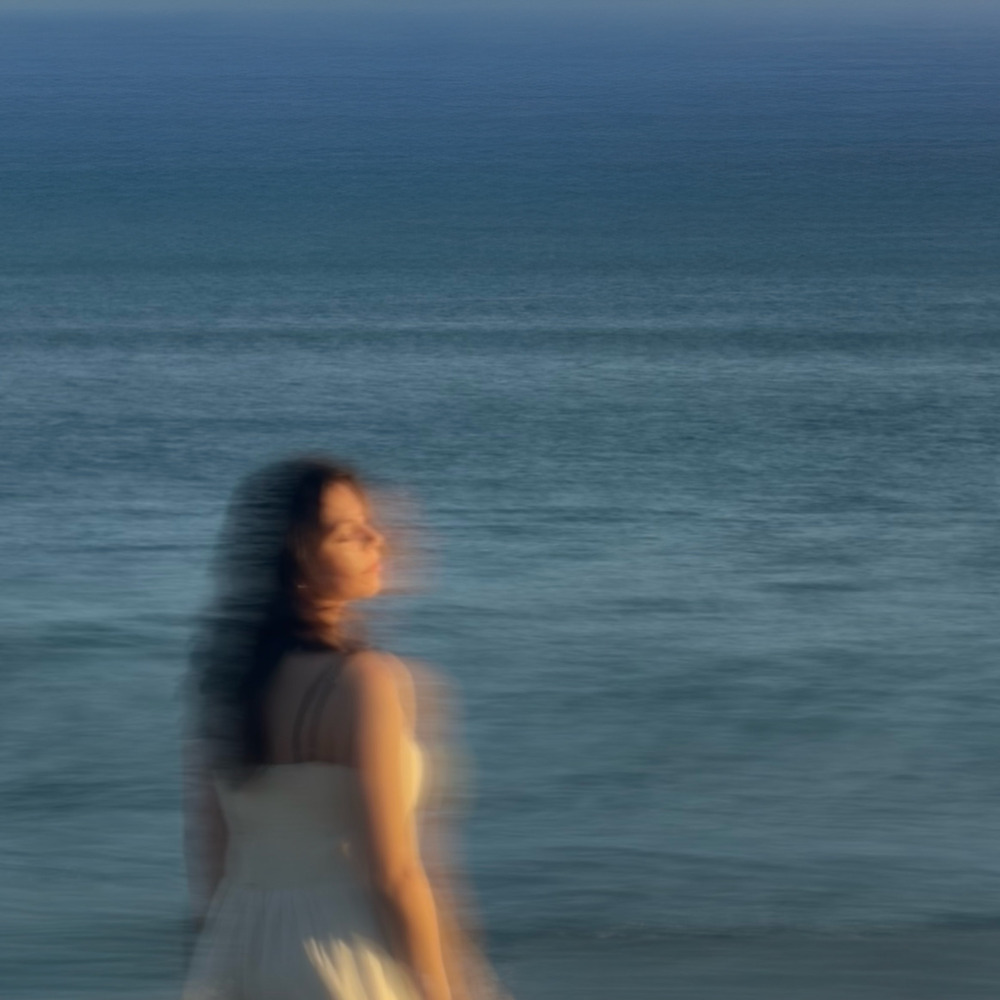 Cherry Park's lead singer standing in front of the ocean, blurred with motion for the Cherry Park EP, Volume #1