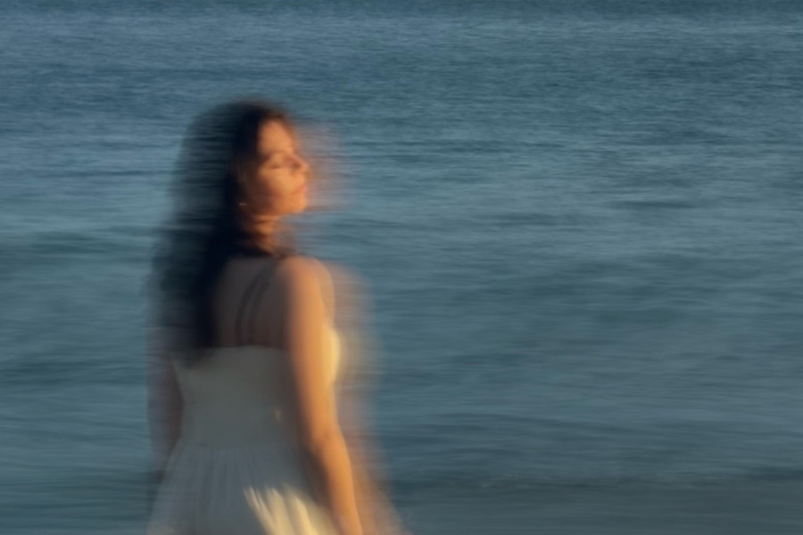 Cherry Park's lead singer standing in front of the ocean, blurred with motion for the Cherry Park EP, Volume #1